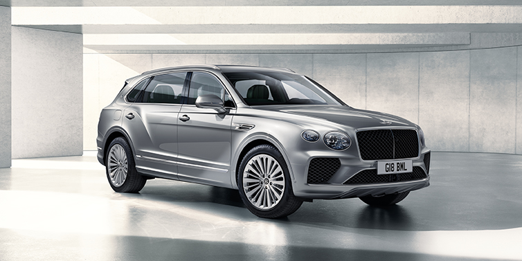 Bentley Phnom Penh Bentley Bentayga Extended Wheelbase SUV front three quarter in Moonbeam paint with a grey background