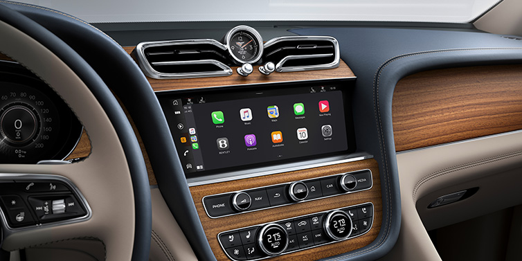 Bentley Phnom Penh Bentley Bentayga Extended Wheelbase Azure SUV front interior centre console with MMI screen showing apps, surrounded by Portland and Imperial Blue coloured hides