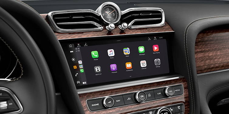 Bentley Phnom Penh Bentley Bentayga Extended Wheelbase SUV front interior centre console MMI screen showing apps surrounded by Beluga black hide and Crown Cut Walnut veneer
